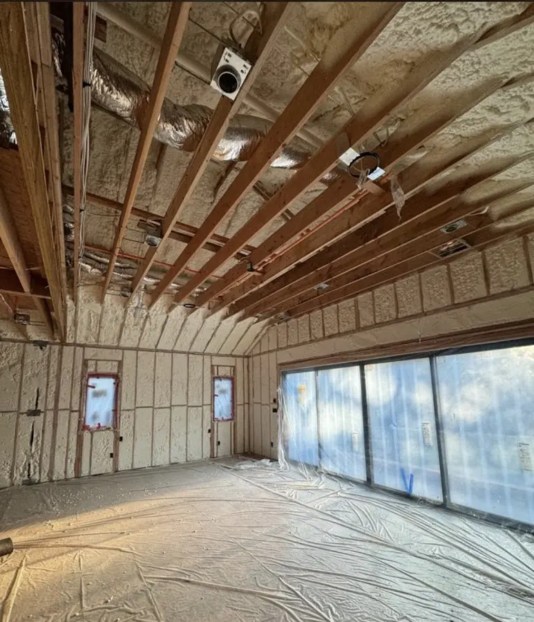 Interior walls and ceiling insulated with spray foam during new construction in Woodstock